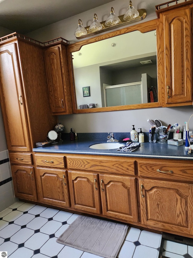 1697 Wildwood Rd, Sterling, MI 48659 - full bathroom with vanity, a shower with shower door, and tile patterned floors