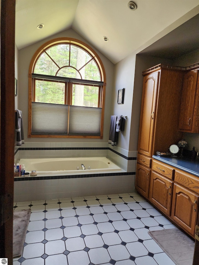 1697 Wildwood Rd, Sterling, MI 48659 - full bath with tile patterned floors, a garden tub, and lofted ceiling