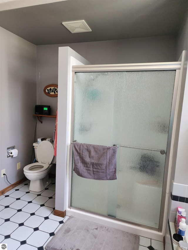 1697 Wildwood Rd, Sterling, MI 48659 - bathroom with toilet, tile patterned floors, a shower stall, and baseboards