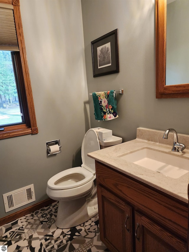 1697 Wildwood Rd, Sterling, MI 48659 - half bathroom with vanity, toilet, and visible vents
