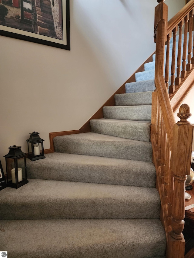 1697 Wildwood Rd, Sterling, MI 48659 - stairway featuring baseboards and carpet flooring