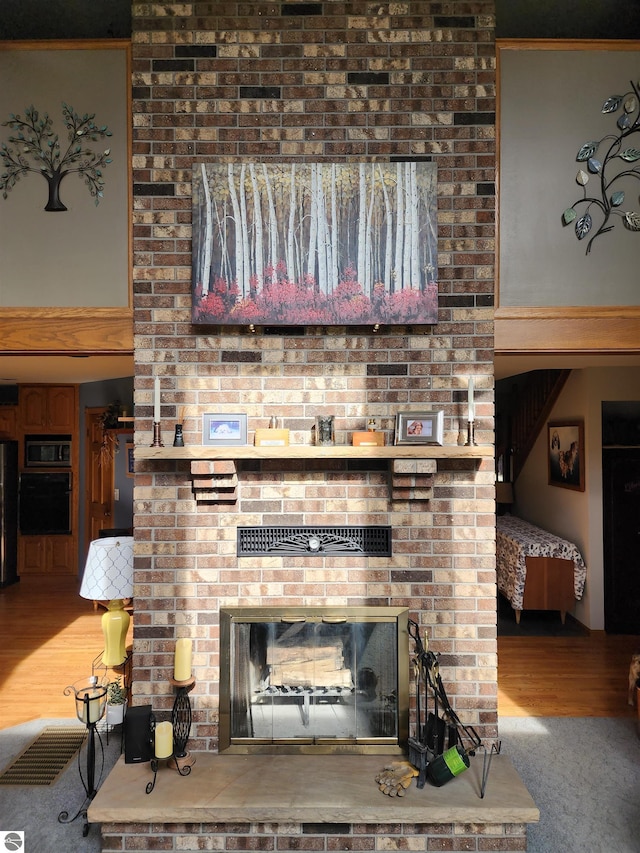 1697 Wildwood Rd, Sterling, MI 48659 - interior space featuring a brick fireplace and wood finished floors