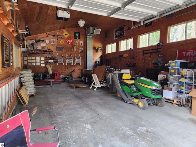 1697 Wildwood Rd, Sterling, MI 48659 - garage featuring a workshop area and a garage door opener