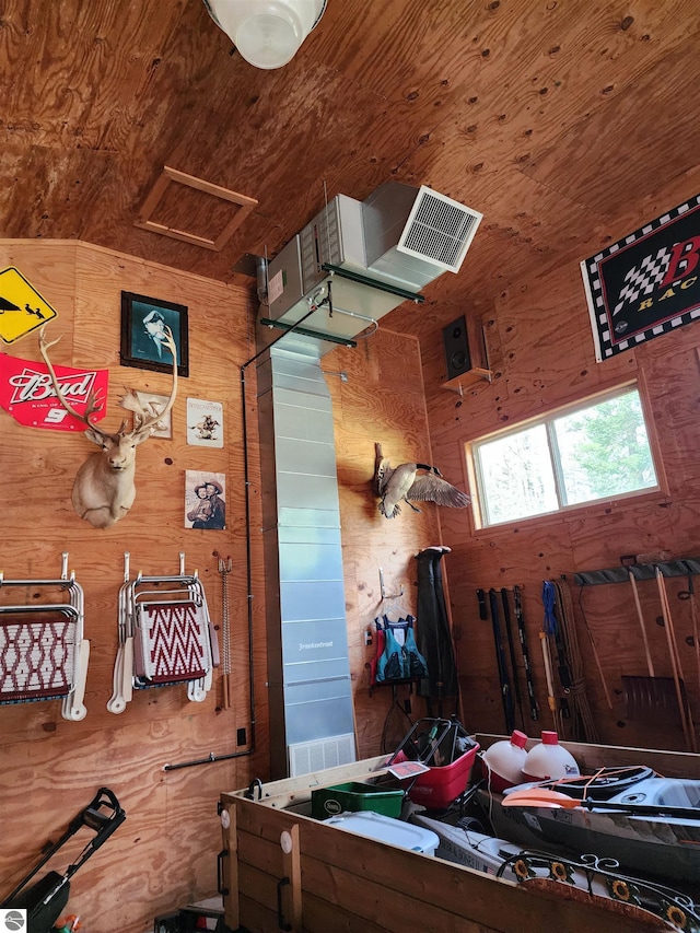 1697 Wildwood Rd, Sterling, MI 48659 - misc room featuring visible vents, wood walls, wood ceiling, and attic access