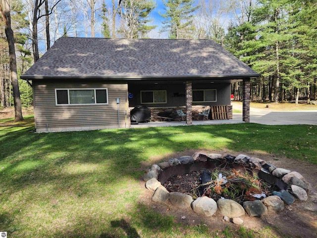 1697 Wildwood Rd, Sterling, MI 48659 - view of front of property with a front lawn, roof with shingles, and an outdoor fire pit
