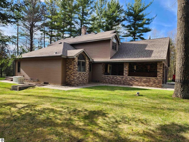 1697 Wildwood Rd, Sterling, MI 48659 - view of front of property with brick siding, a chimney, and a front yard