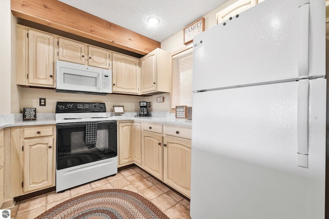 kitchen with light countertops, a textured ceiling, light tile patterned flooring, and white appliances