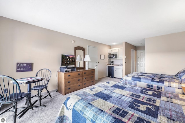 bedroom featuring refrigerator, a sink, light carpet, and baseboards
