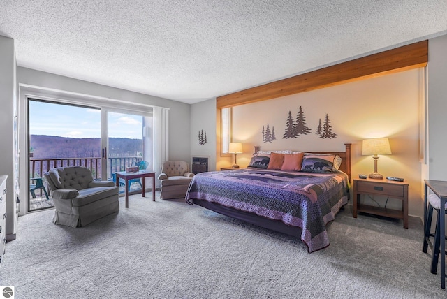 carpeted bedroom featuring access to outside and a textured ceiling