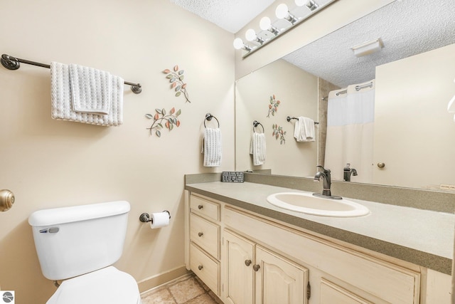 full bathroom with vanity, a textured ceiling, baseboards, and toilet