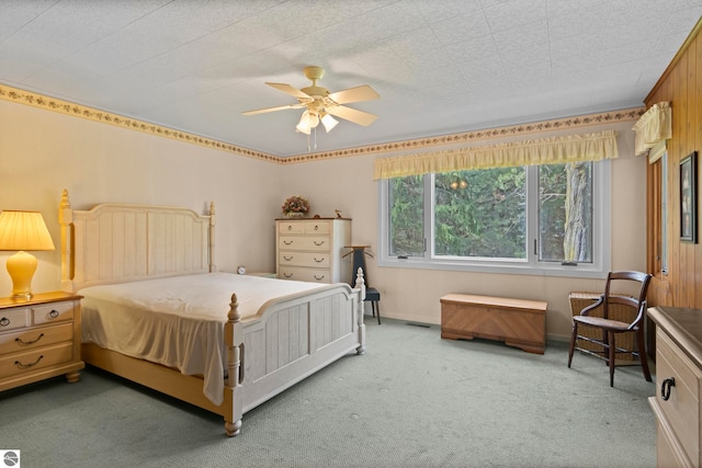 bedroom featuring carpet floors, a ceiling fan, and baseboards