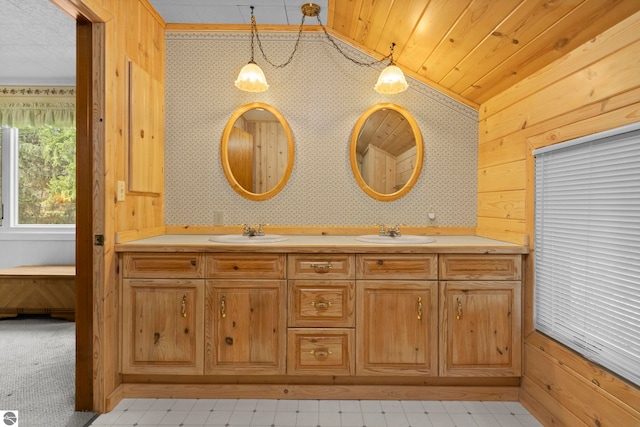 full bath featuring double vanity, a sink, vaulted ceiling, and wood walls