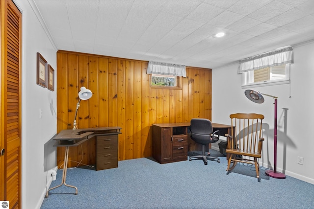 carpeted office with wooden walls and baseboards