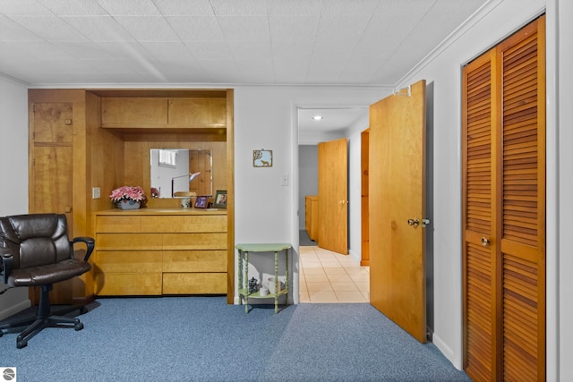 interior space with ornamental molding and a closet
