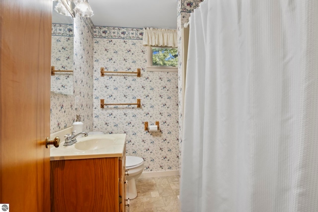 bathroom with vanity, toilet, baseboards, wallpapered walls, and a shower with curtain