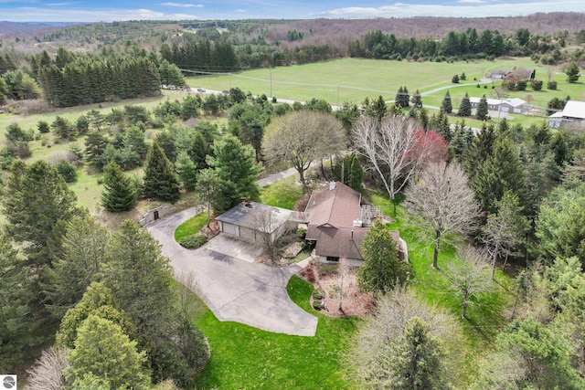 bird's eye view with a view of trees and a rural view