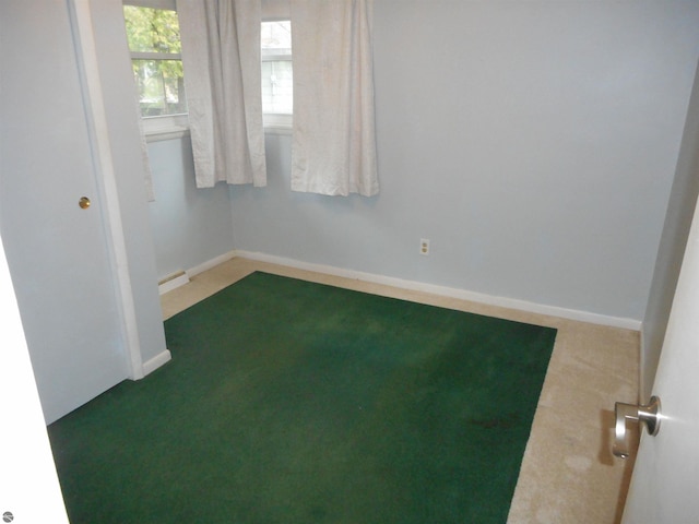 empty room with baseboards and carpet flooring