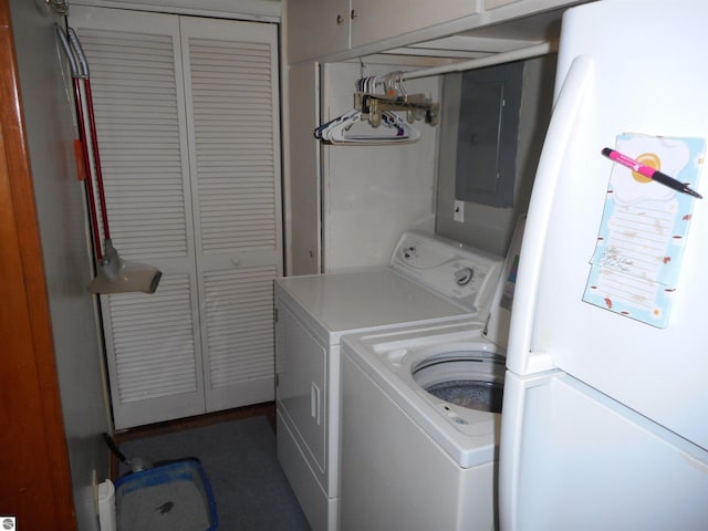 washroom featuring cabinet space, washing machine and dryer, and electric panel