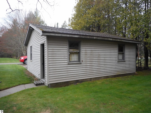 view of side of property with a yard