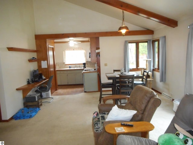 living area with ceiling fan, lofted ceiling with beams, and light carpet