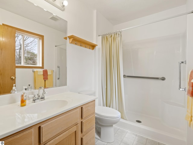 8377 Orchard Hill Rd, Beulah, MI 49617 - bathroom featuring tile patterned flooring, vanity, toilet, a shower stall, and visible vents