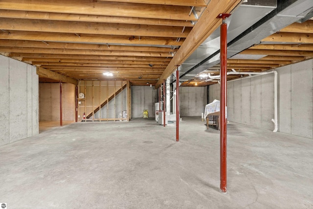 8377 Orchard Hill Rd, Beulah, MI 49617 - unfinished basement featuring water heater and stairway