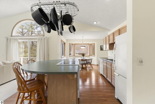 8377 Orchard Hill Rd, Beulah, MI 49617 - kitchen with white appliances, dark countertops, lofted ceiling, and a breakfast bar area