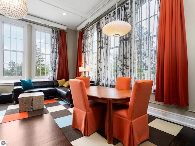 dining space with wood finished floors