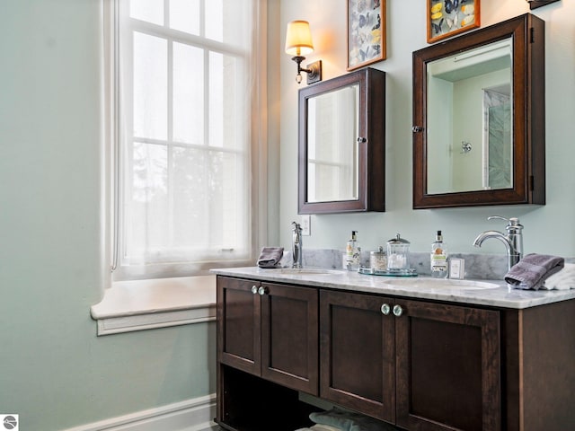 bathroom with double vanity and a sink