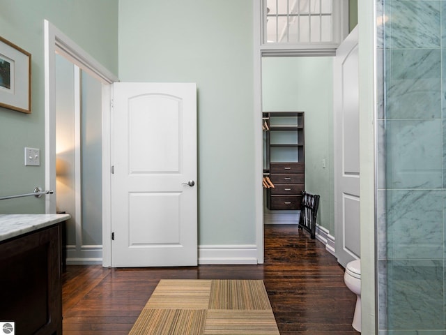 interior space with baseboards and dark wood-style floors
