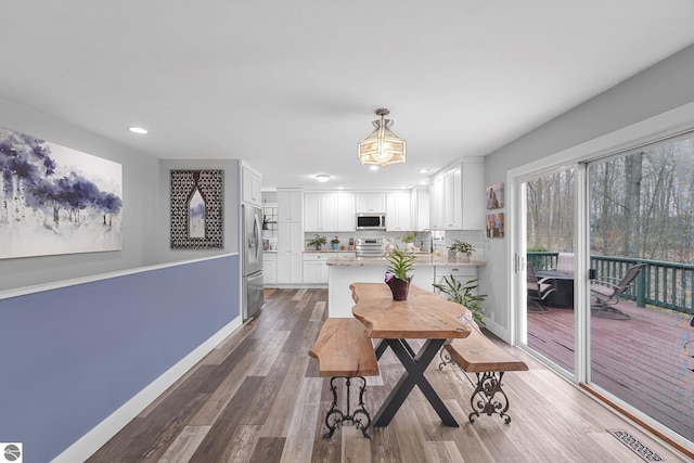 dining area featuring recessed lighting, baseboards, visible vents, and wood finished floors