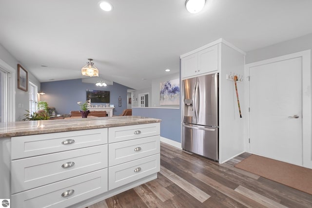 kitchen featuring dark wood-style flooring, white cabinetry, vaulted ceiling, and stainless steel fridge with ice dispenser