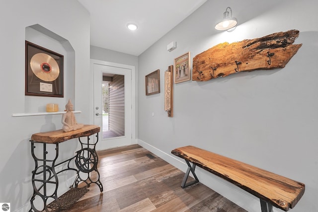 corridor with baseboards, recessed lighting, and wood finished floors