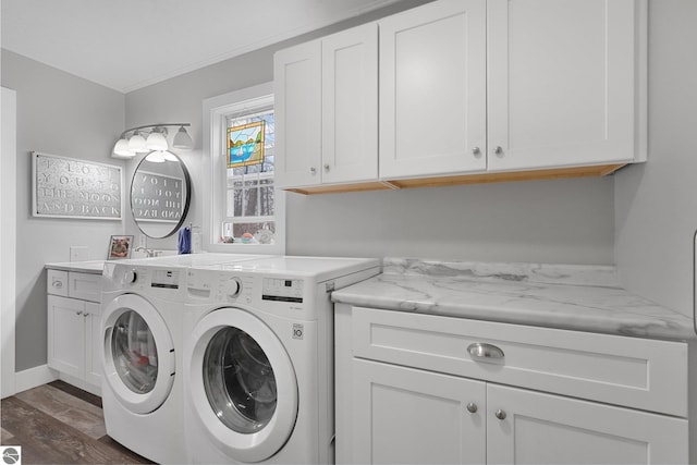 washroom with washer and dryer, baseboards, dark wood-style floors, and cabinet space