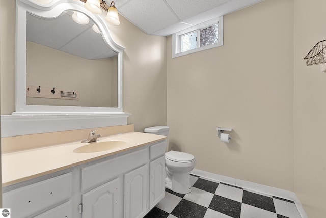bathroom featuring tile patterned floors, baseboards, vanity, and toilet