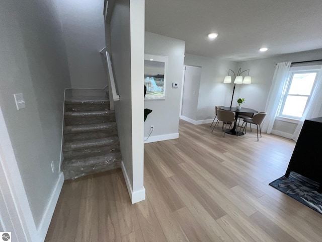 stairs featuring baseboards, recessed lighting, and wood finished floors