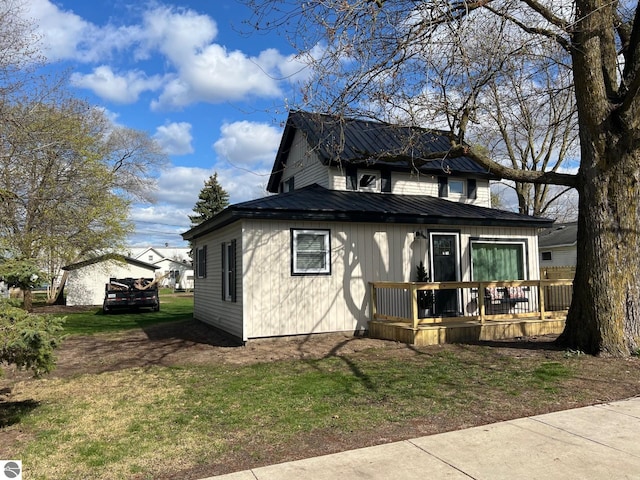 bungalow-style home featuring metal roof and a front yard