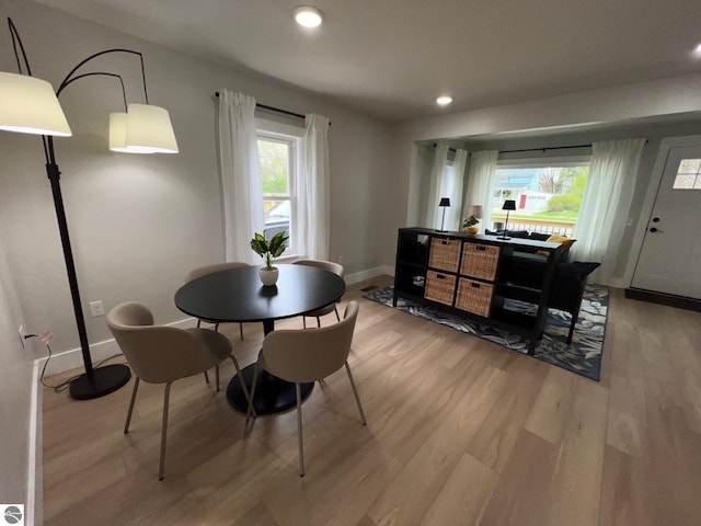dining area featuring baseboards, recessed lighting, and wood finished floors