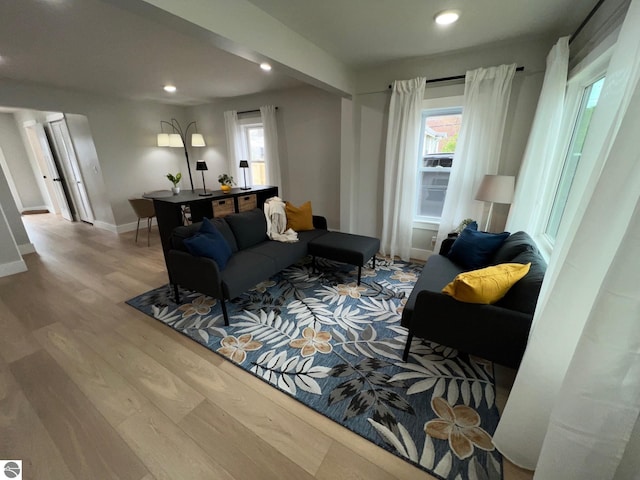 living room featuring baseboards, recessed lighting, and wood finished floors