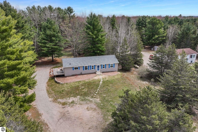 birds eye view of property with a forest view