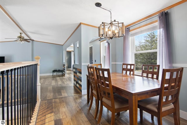 dining space with baseboards, ornamental molding, ceiling fan with notable chandelier, and dark wood-style flooring