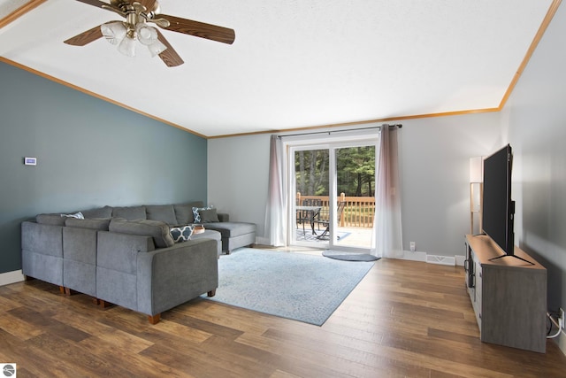 living area featuring a ceiling fan, visible vents, dark wood finished floors, lofted ceiling, and ornamental molding