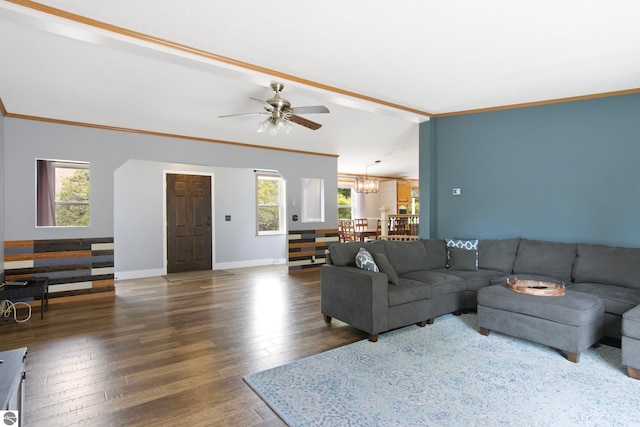 living room featuring baseboards, ornamental molding, ceiling fan with notable chandelier, and wood finished floors