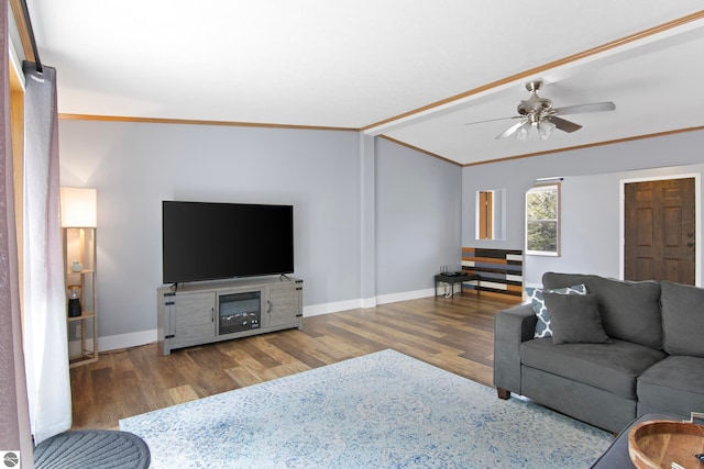 living room featuring crown molding, baseboards, ceiling fan, and wood finished floors