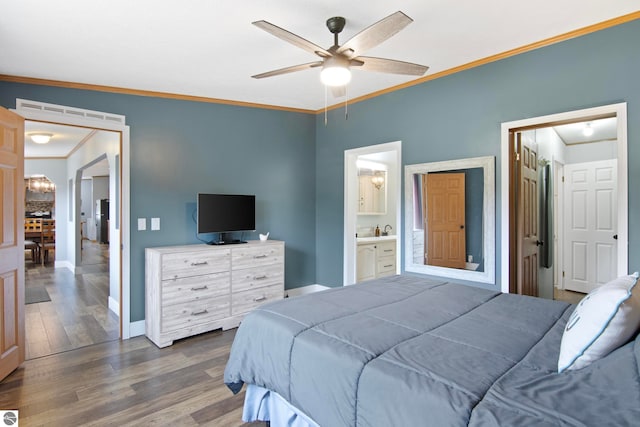 bedroom with connected bathroom, a ceiling fan, baseboards, wood finished floors, and ornamental molding