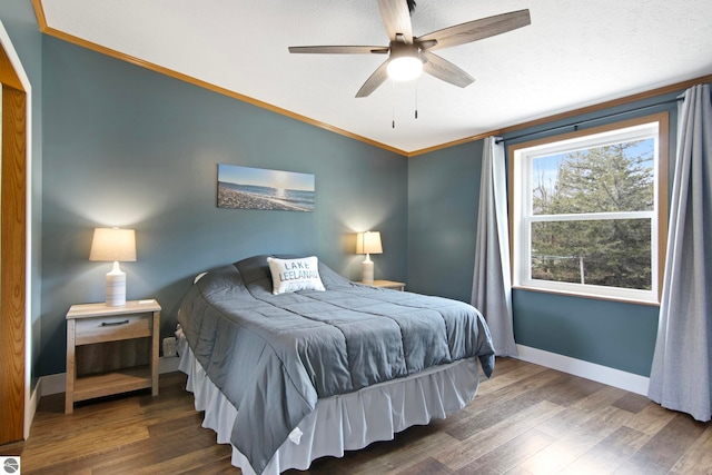 bedroom with crown molding, baseboards, ceiling fan, and wood finished floors