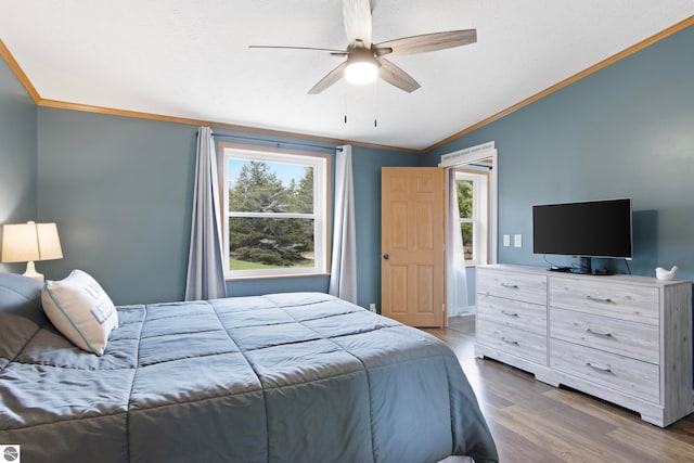 bedroom featuring crown molding, ceiling fan, wood finished floors, and vaulted ceiling