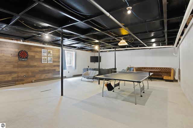 game room featuring a baseboard heating unit and wood walls