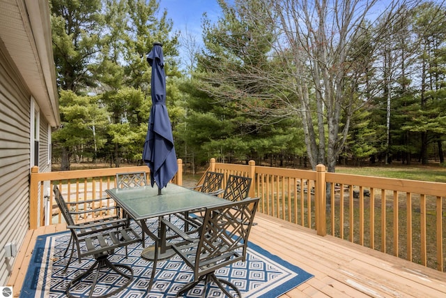 wooden deck featuring outdoor dining area