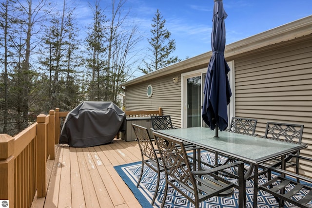 deck featuring grilling area and outdoor dining area